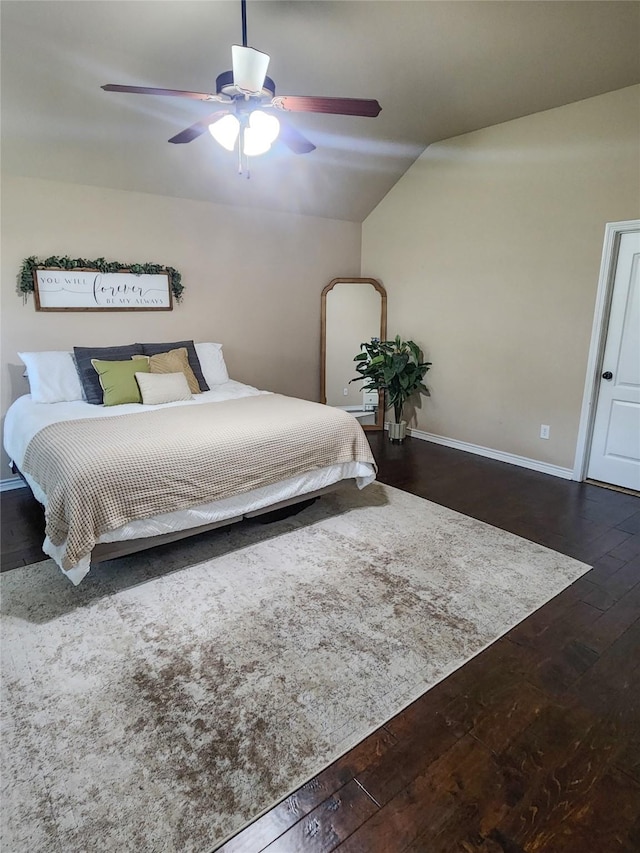 bedroom with ceiling fan, dark hardwood / wood-style floors, and lofted ceiling