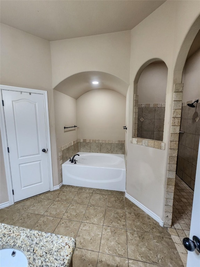 bathroom with tile patterned flooring and separate shower and tub