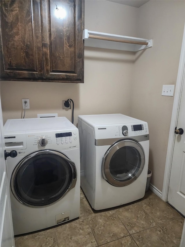 laundry area featuring cabinets and washer and clothes dryer