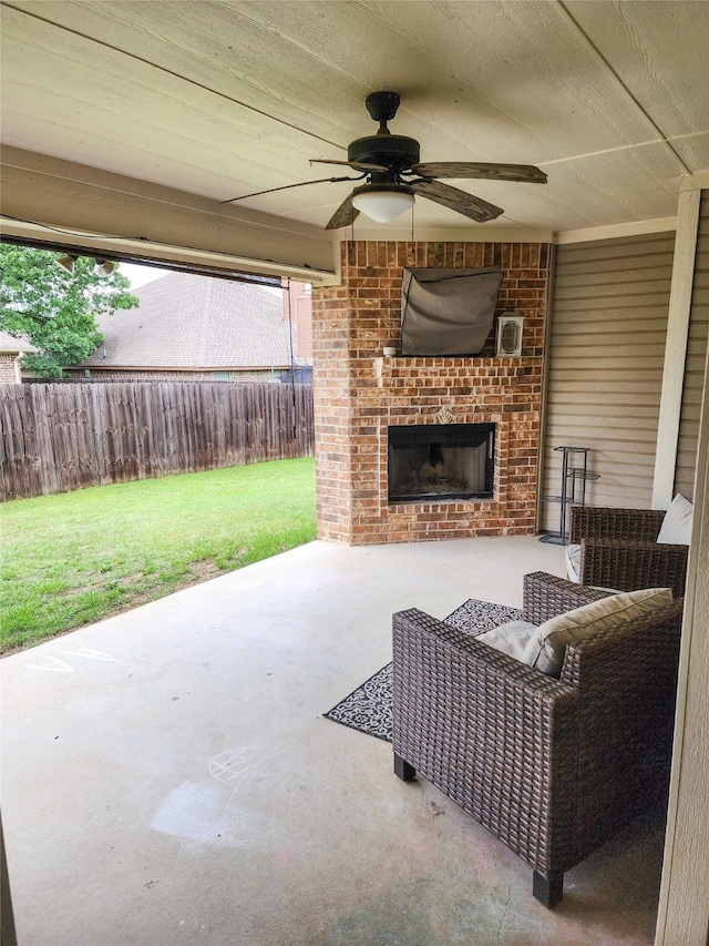 view of patio / terrace featuring an outdoor brick fireplace and ceiling fan