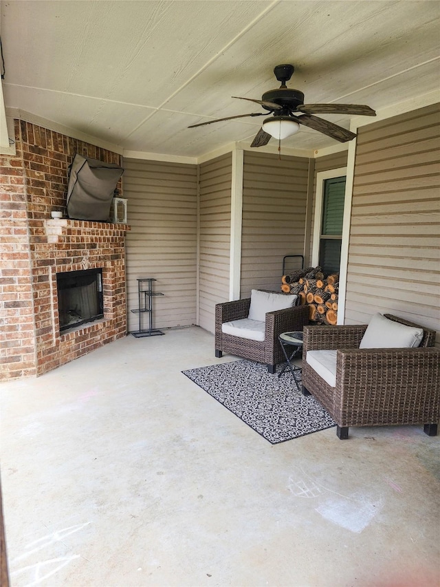 view of patio featuring an outdoor brick fireplace and ceiling fan