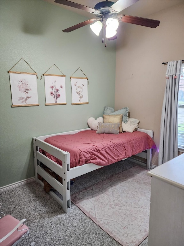 bedroom featuring ceiling fan and carpet