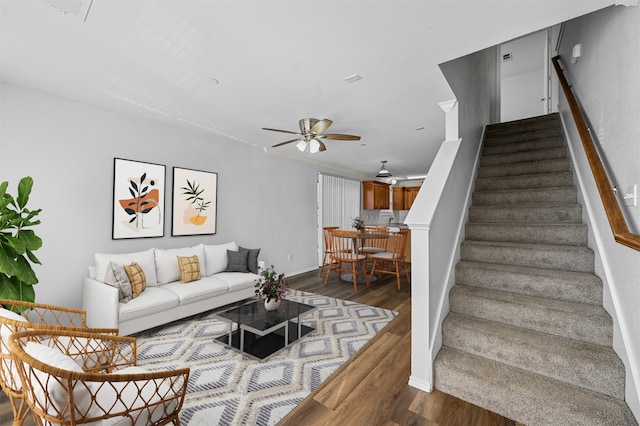 living room with ceiling fan and dark hardwood / wood-style floors