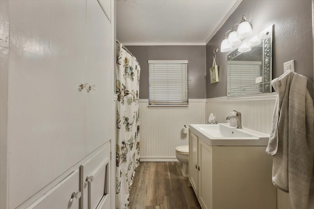 bathroom featuring crown molding, vanity, wood-type flooring, a shower with curtain, and toilet