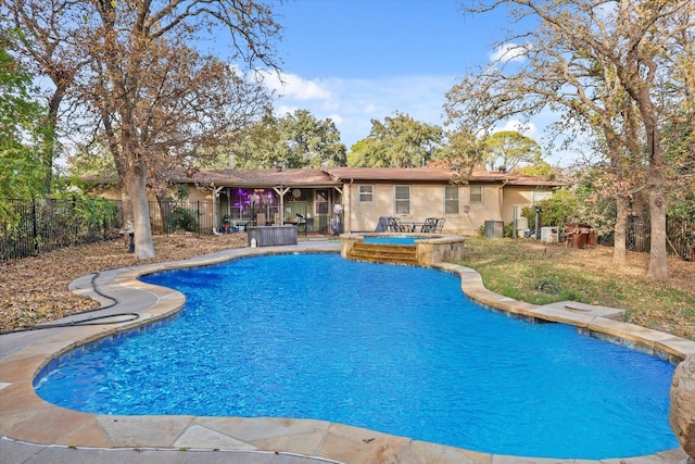 view of swimming pool featuring an in ground hot tub