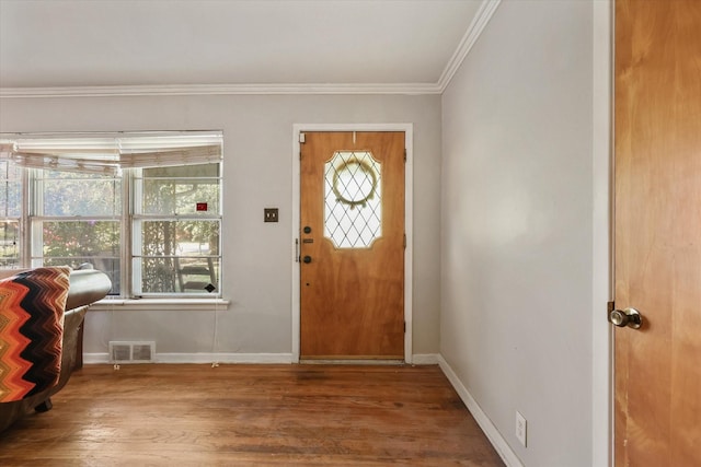 entrance foyer with ornamental molding and hardwood / wood-style floors