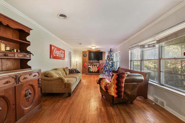 living room with ornamental molding and hardwood / wood-style floors