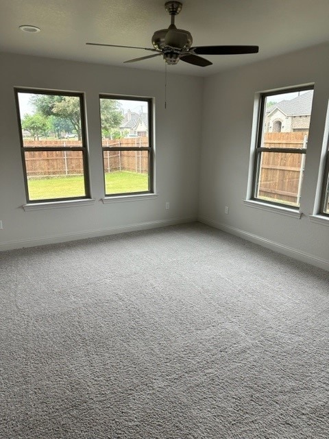 empty room featuring carpet and ceiling fan