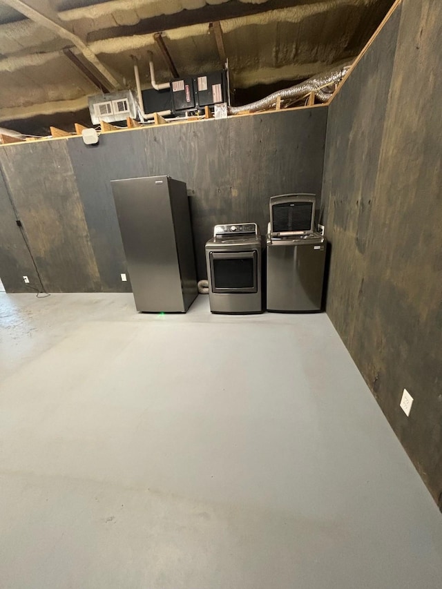 basement with independent washer and dryer and stainless steel refrigerator