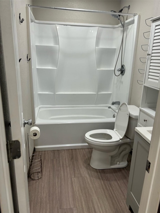 full bathroom featuring wood-type flooring, shower / bathing tub combination, vanity, and toilet