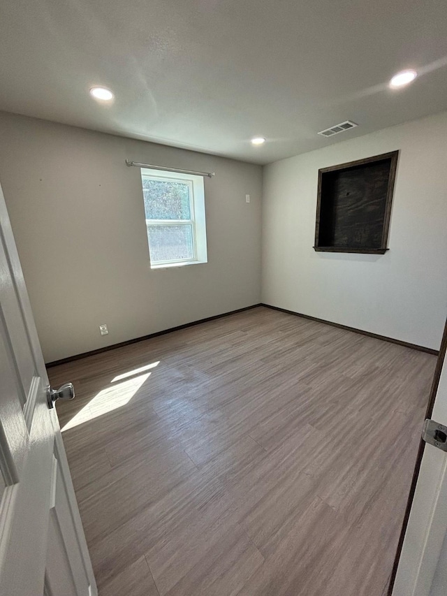 unfurnished room with light hardwood / wood-style flooring