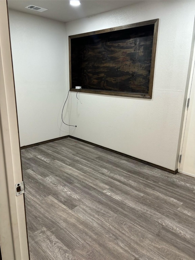 empty room with dark wood-type flooring