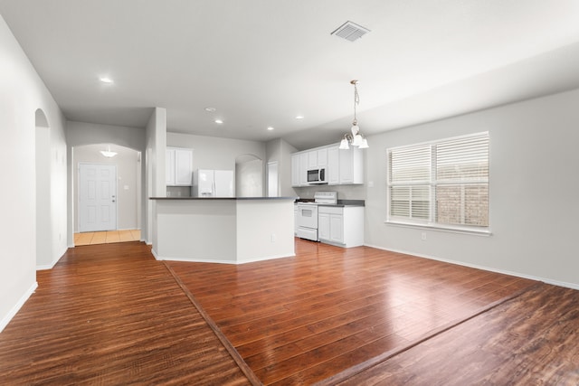 unfurnished living room featuring dark hardwood / wood-style flooring and a notable chandelier