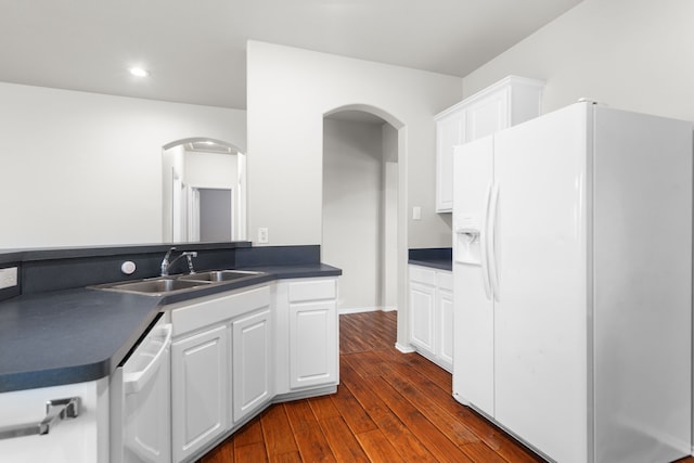 kitchen featuring white cabinets, white appliances, dark hardwood / wood-style floors, and sink