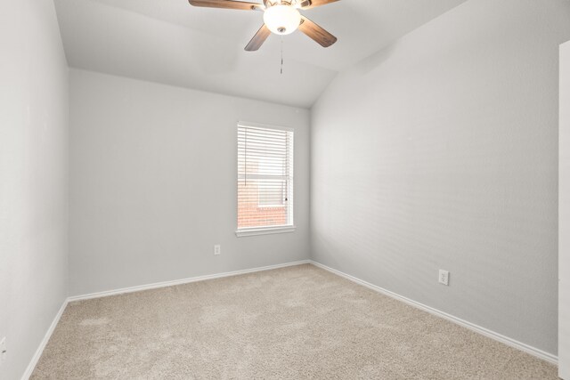 unfurnished room with ceiling fan, light colored carpet, and vaulted ceiling