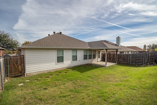 rear view of property with a lawn and a patio area