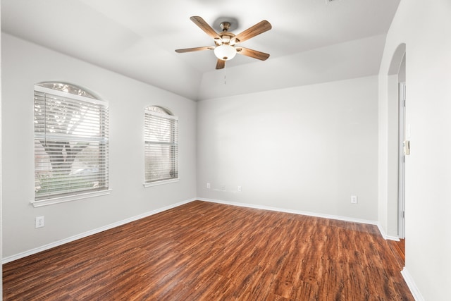 spare room featuring dark hardwood / wood-style floors and ceiling fan