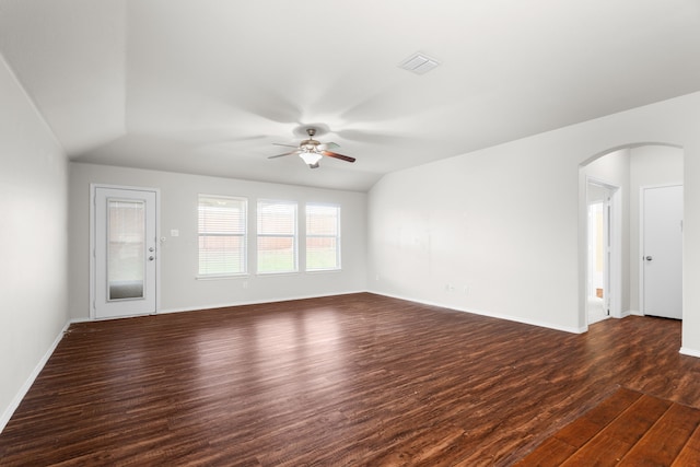 unfurnished living room with ceiling fan, dark wood-type flooring, and vaulted ceiling