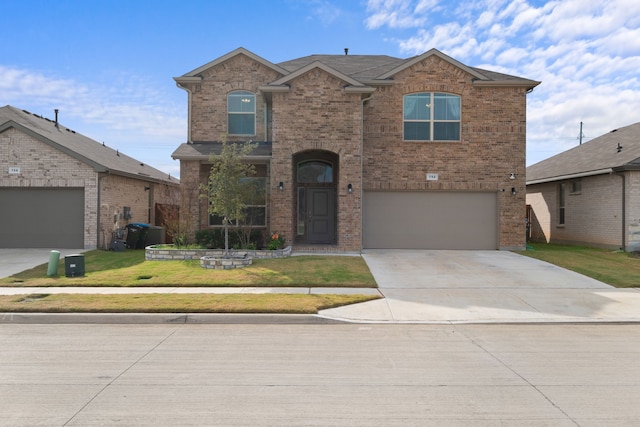 front facade featuring a garage and a front yard