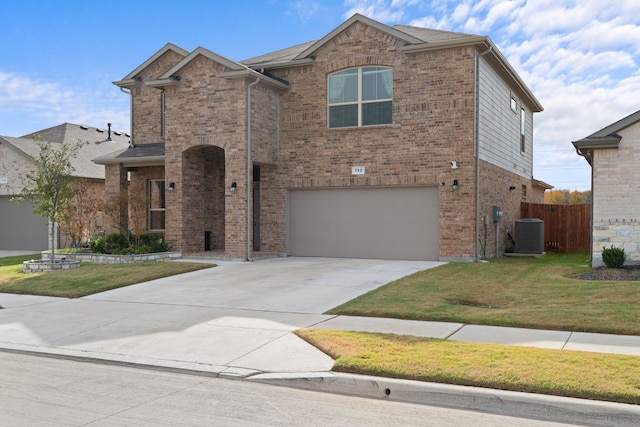 view of front of property with a front lawn, cooling unit, and a garage