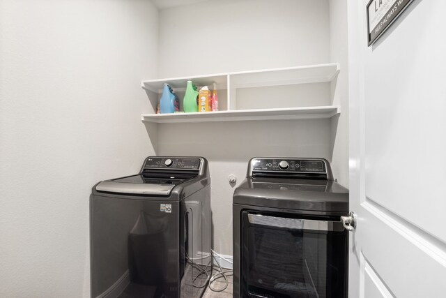 clothes washing area featuring washing machine and clothes dryer