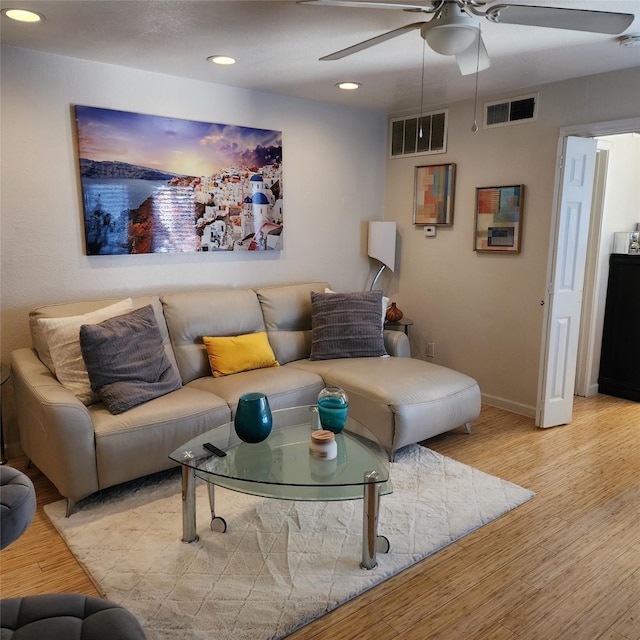 living room with light wood-type flooring and ceiling fan