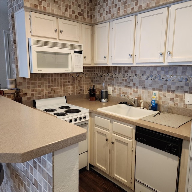 kitchen with white cabinetry, sink, backsplash, dark hardwood / wood-style flooring, and white appliances