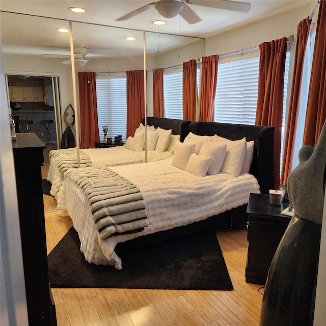 bedroom with ceiling fan and light hardwood / wood-style floors