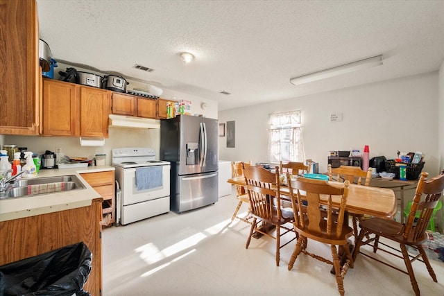 kitchen featuring electric range, stainless steel fridge with ice dispenser, sink, and a textured ceiling