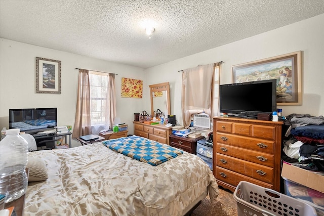 bedroom featuring cooling unit and a textured ceiling