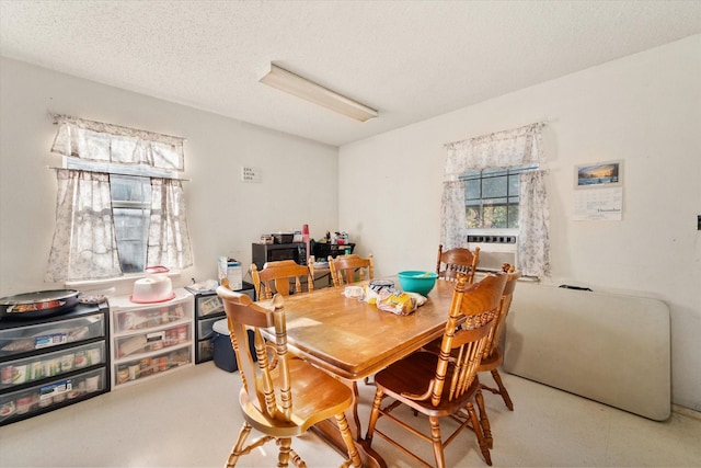 dining room with cooling unit and a textured ceiling