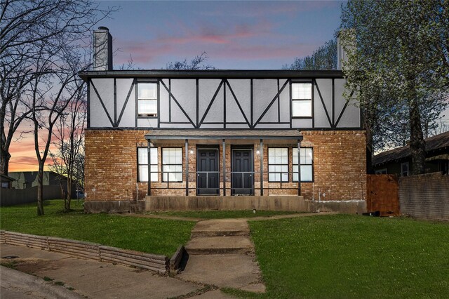 137 Montego Dr, Mesquite, TX 75149 - english style home with brick siding, a chimney, stucco siding, and a porch