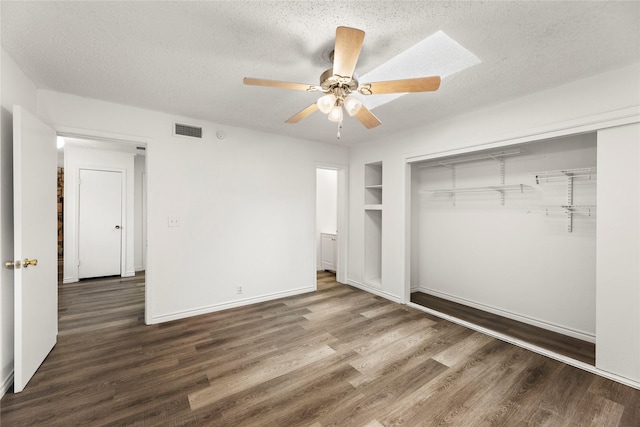 unfurnished bedroom with a textured ceiling, ceiling fan, and dark wood-type flooring