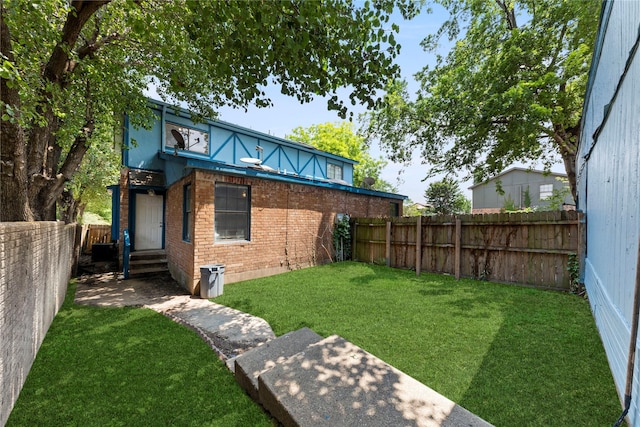 rear view of house featuring a yard