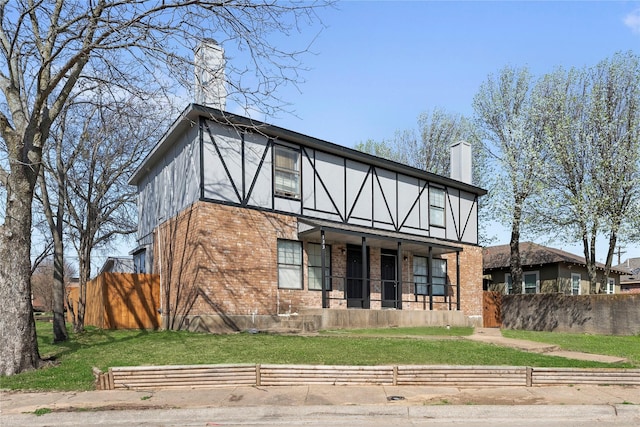 137 Montego Dr, Mesquite, TX 75149 - tudor house featuring brick siding, a chimney, and stucco siding