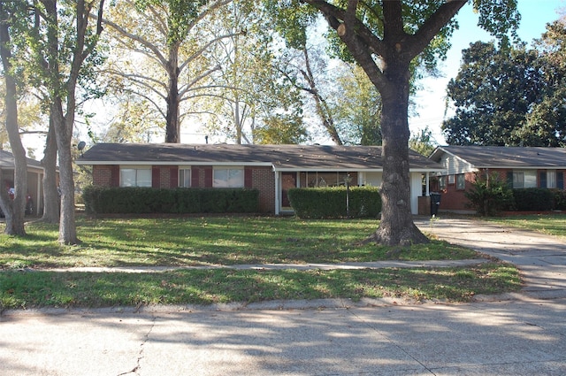 ranch-style home with a front lawn