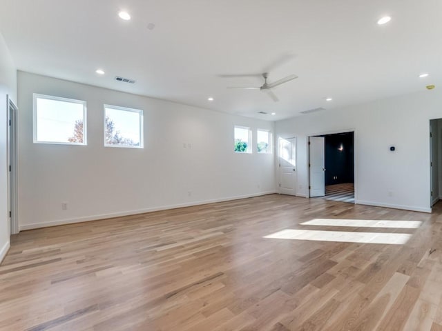 unfurnished room with ceiling fan, a healthy amount of sunlight, and light hardwood / wood-style flooring