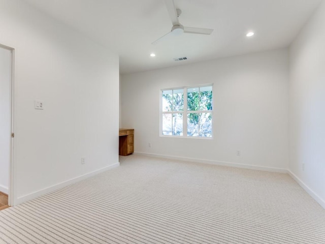 carpeted empty room featuring ceiling fan