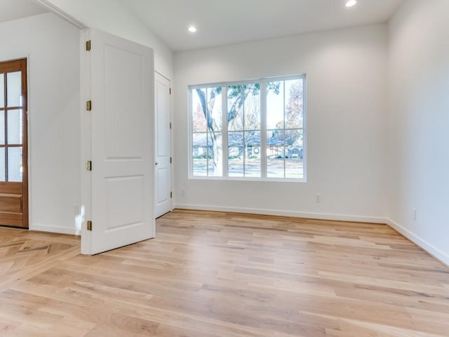 interior space featuring lofted ceiling and light hardwood / wood-style flooring