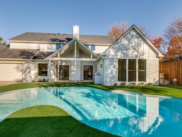 view of swimming pool featuring a lawn