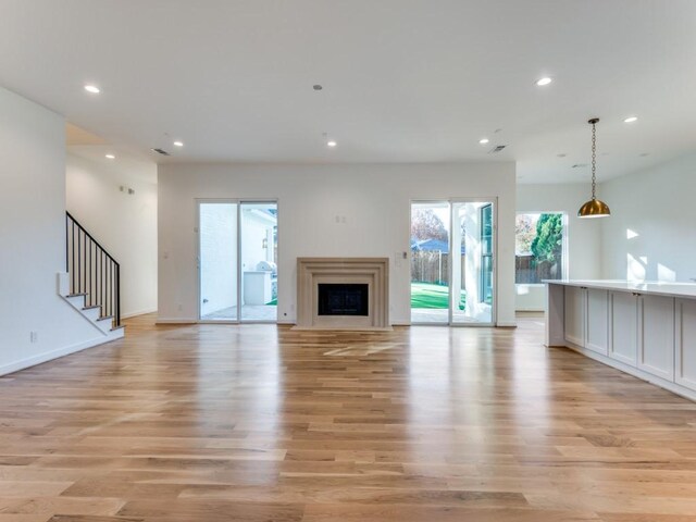 unfurnished living room with light wood-type flooring