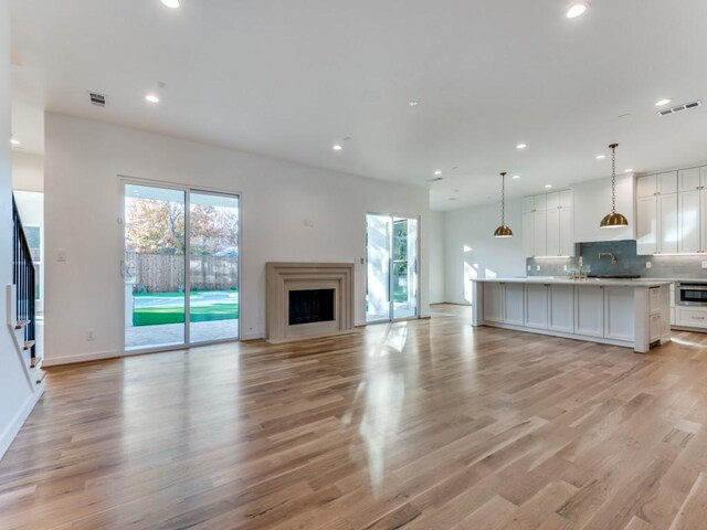 unfurnished living room with light wood-type flooring