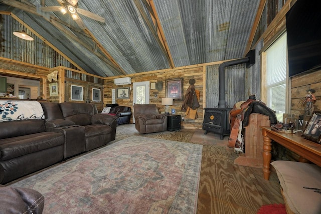 living room featuring a wood stove, high vaulted ceiling, an AC wall unit, wood-type flooring, and wooden walls