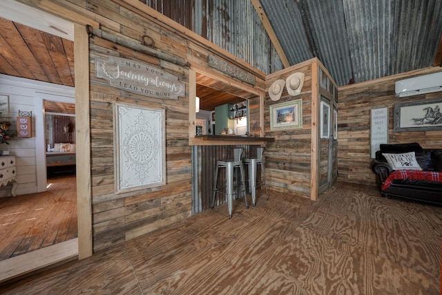 bar featuring hardwood / wood-style floors, an AC wall unit, wooden walls, vaulted ceiling, and wood ceiling