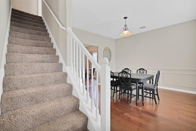 stairs featuring hardwood / wood-style floors