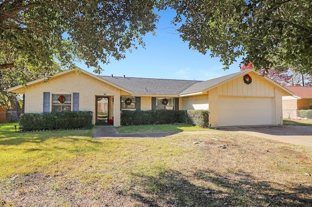 ranch-style house featuring a front yard and a garage