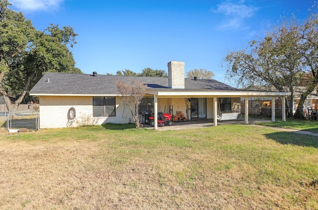 back of house with a yard and a patio