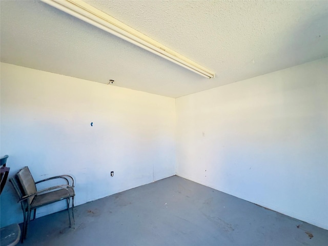 interior space featuring concrete flooring and a textured ceiling