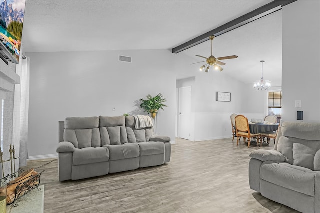 living room with vaulted ceiling with beams, light hardwood / wood-style floors, and ceiling fan with notable chandelier