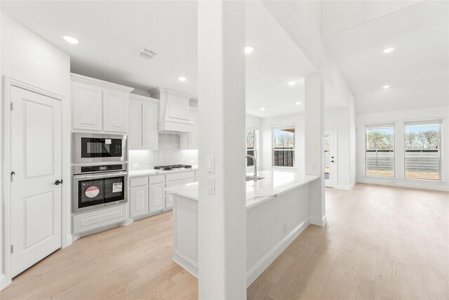 kitchen featuring a fireplace, ceiling fan, and dishwasher